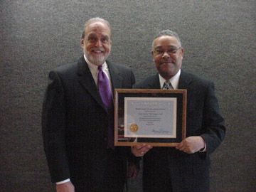 County Executive Dennis Levinson presents Department Head Forrest Gilmore with a certificate honoring Atlantic County's Child Support Team.